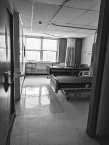 black and white hospital room with two empty beds