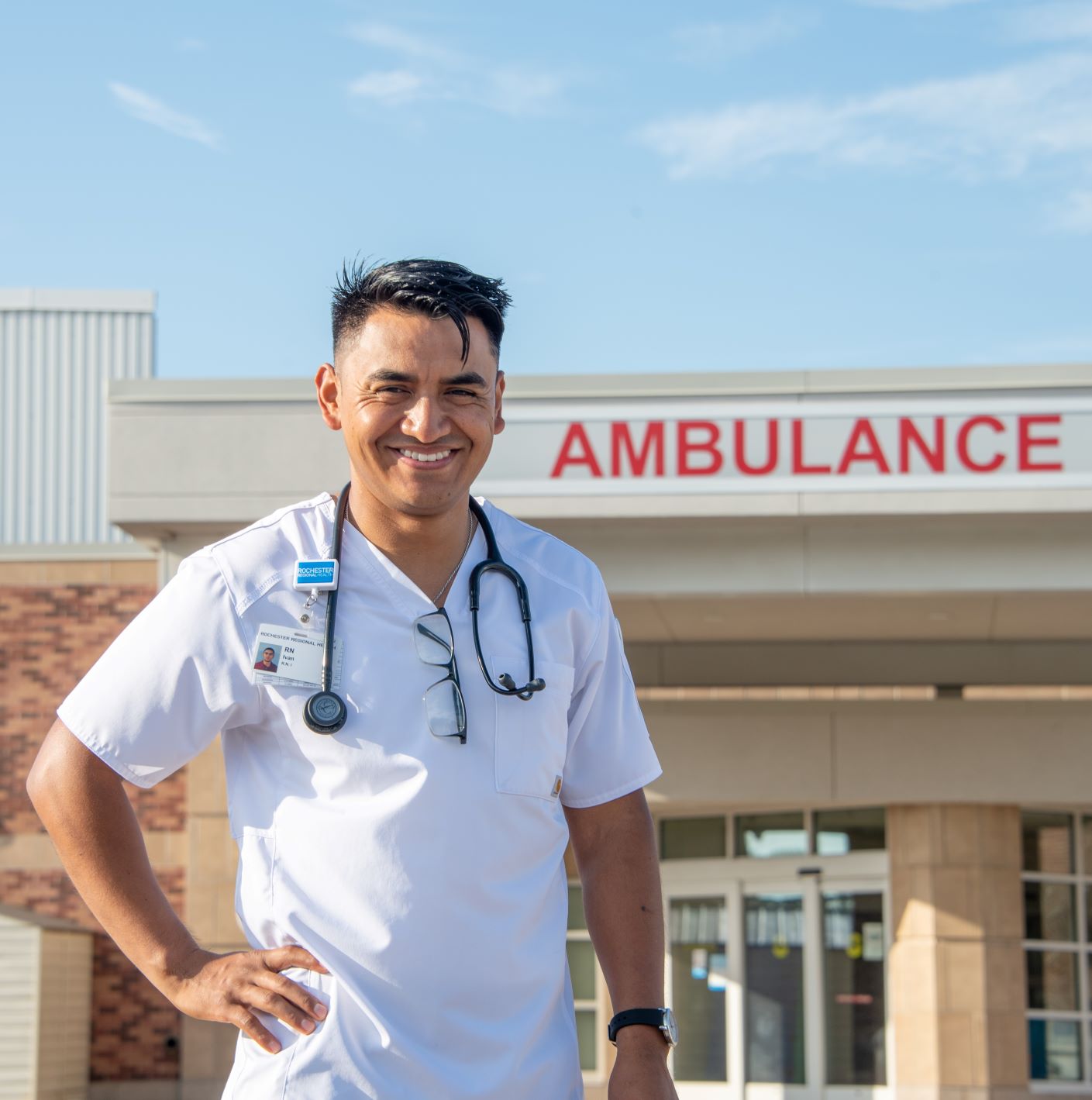 Nurse standing outside hospital emergency entrance