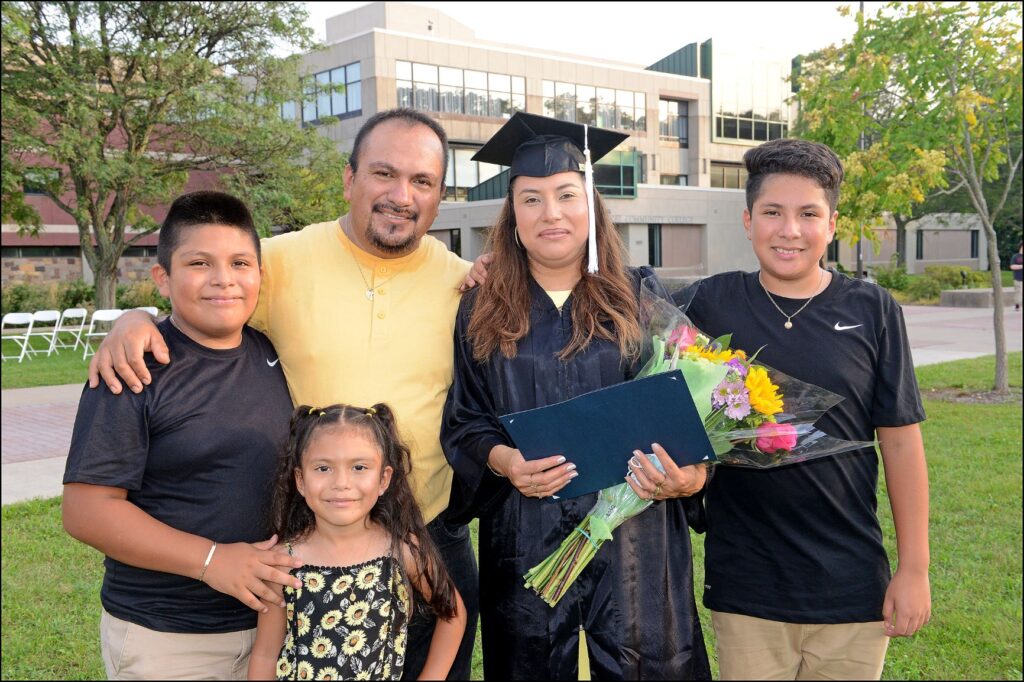 Woman graduate with husband and three children
