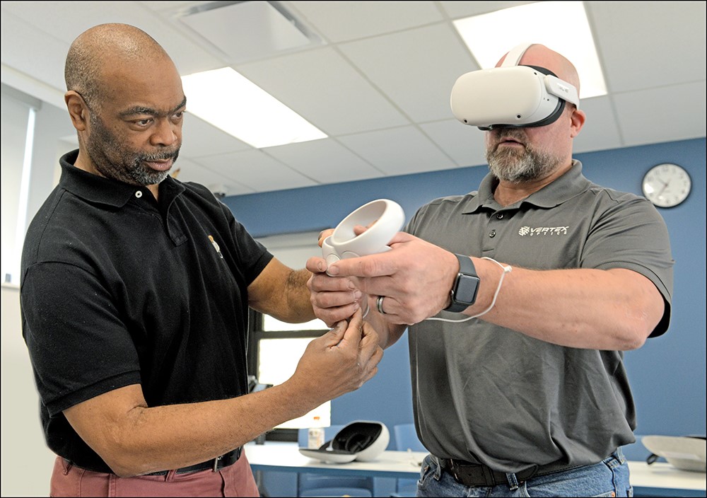Instructor with student using virtual reality headset 